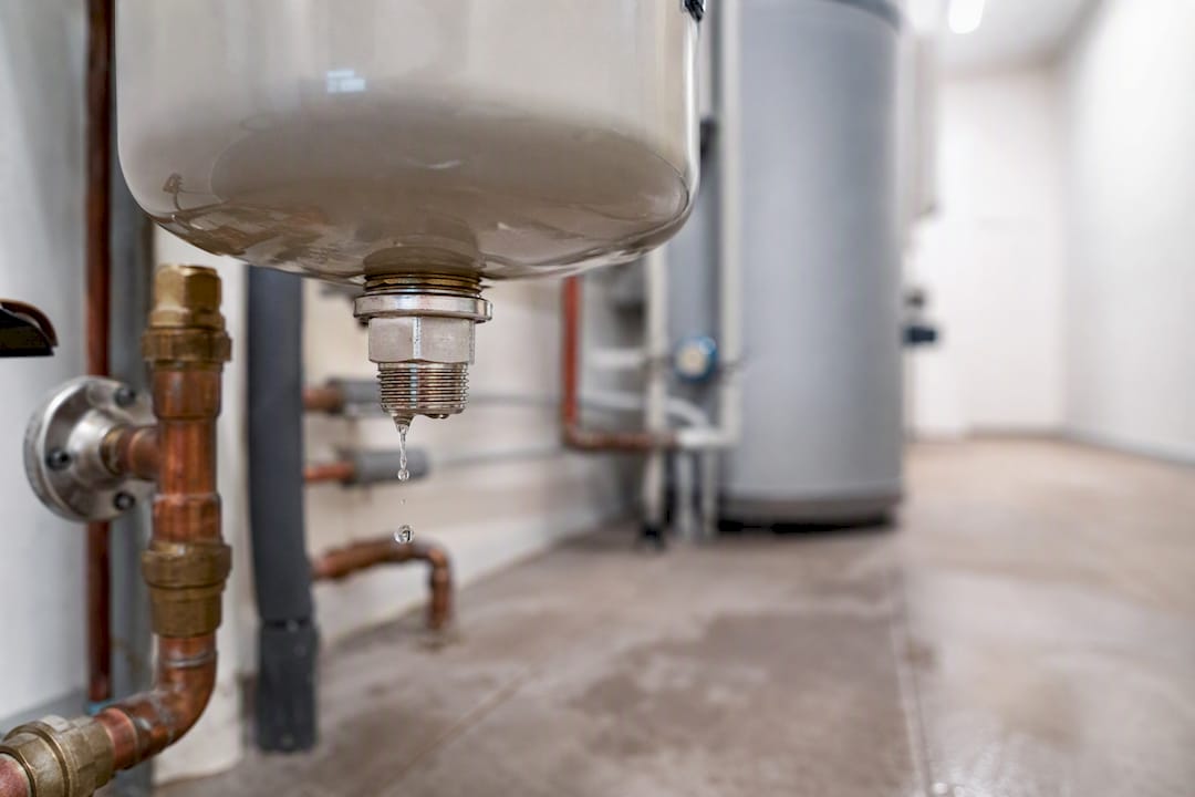 Close-up of leaking expansion tank fitting