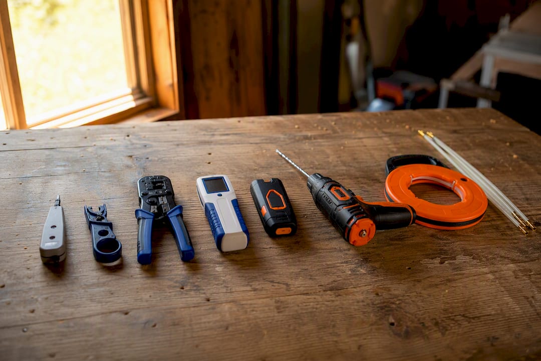 Ethernet cable installation tools laid out on table